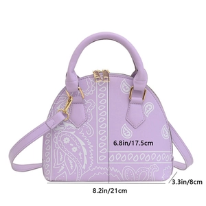 Detail view of purple paisley shell bag showing golden zippers and 17.5cm height dimension