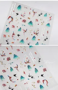Macro detail of 3D embossed nail stickers featuring phoenix and crane motifs with gold accents