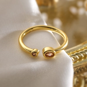 Elegant 18K gold-plated open ring with asymmetric champagne zircons on white silk