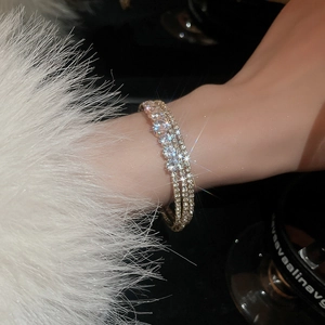 Detail of a luxury multi-layer zircon bracelet with sparkling crystals on a hand