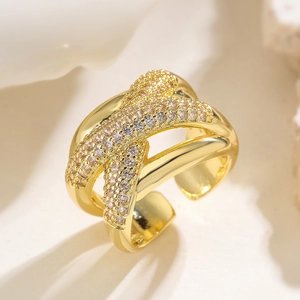 Macro detail of gold geometric ring with micro-set zircon stones on white texture