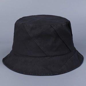 Detail of black cotton bucket hat showing heavy diagonal stitching and canvas texture
