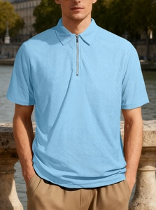 Detail of light blue men's polo shirt featuring zipper collar and waffle texture fabric