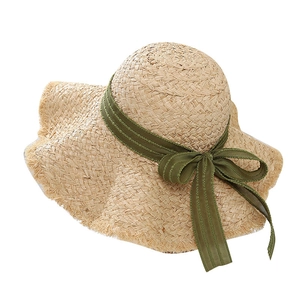 Beige raffia sun hat with flat top, olive green ribbon bow and frayed edges