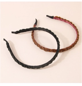 Detail view of black and brown beaded headbands showing the intricate braided texture