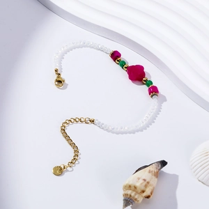 Detail of bohemian freshwater pearl bracelet with magenta stone and gold lobster clasp