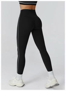 Rear view detail of high waisted black yoga leggings with white contrast side stripes