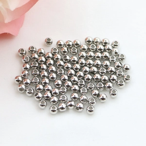 Macro shot of polished silver plated round beads with center holes for DIY jewelry making