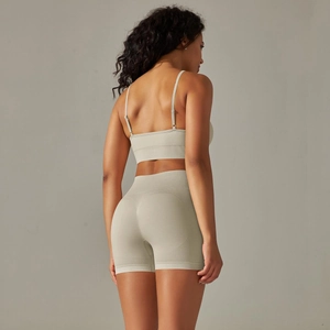 Back view of a seamless ribbed sports bra and high-waist shorts set in sage green