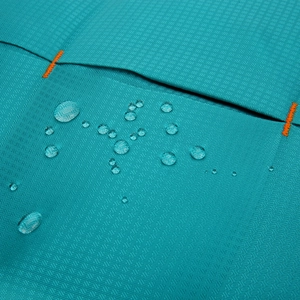 Waterproof turquoise hiking backpack fabric detail with diamond texture and water drops