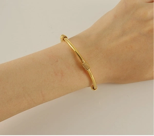 Detailed shot of an 18K gold plated stainless steel bracelet with three beaded textures