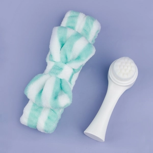 Detail of mint green striped bow headband and ergonomic facial cleansing brush set