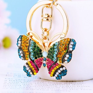 Detailed macro view of gold butterfly keychain with vibrant colorful rhinestones