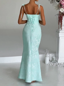Detailed back view of mint green jacquard evening dress with elegant lace-up strap design