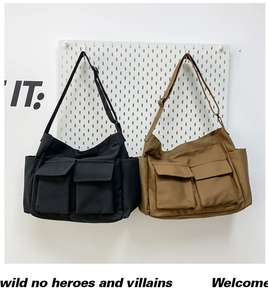 Detail of high-density canvas messenger bags in black and khaki with adjustable straps