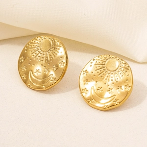 Detailed macro view of gold 304 stainless steel celestial earrings with sun and moon motifs