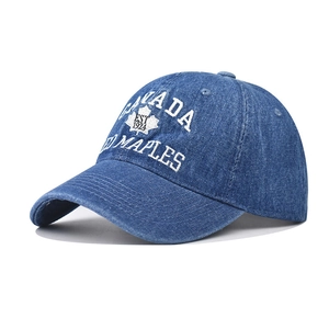 Détail de la broderie CANADA et du logo feuille d'érable sur casquette en jean bleu