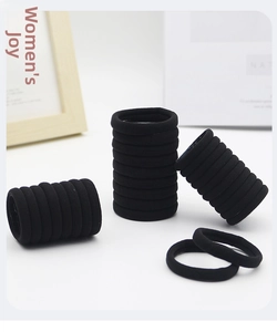 Detail of seamless black high-elasticity hair ties with soft frosted texture in a bulk pack