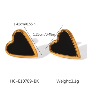 Detailed view of heart-shaped gold studs with black core including size measurements