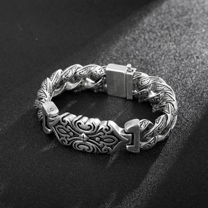 Detailed view of vintage silver steel bracelet with intricate cross pattern and sturdy clasp