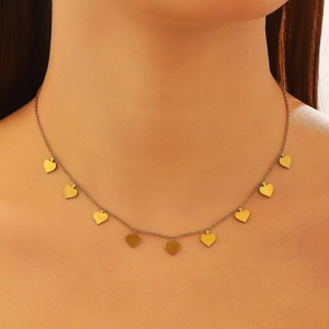 Close-up of gold stainless steel necklace with multiple heart pendants on model