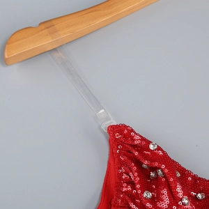 Detail of red sequined dress with silver rhinestones and clear adjustable straps
