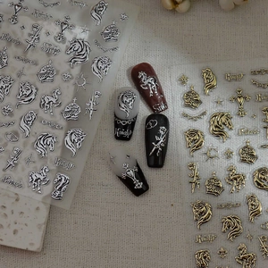 Detailed view of metallic gothic nail stickers with knight and rose embossed designs