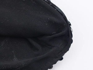 Macro view of black mesh fabric with sewn-on shiny sequins for women's party shirts