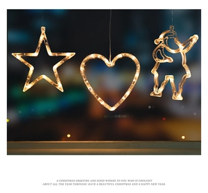 Detail view of star, heart, and Santa LED suction lights with warm yellow glow