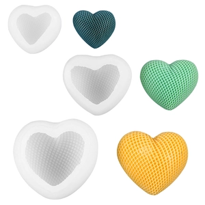 Three sizes of 3D textured heart silicone molds with blue, green, and yellow finished candles