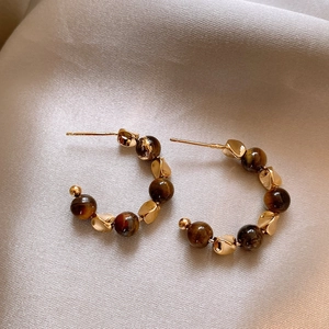 Retro 18K gold plated C-shaped hoop earrings with brown tiger eye beads on beige silk
