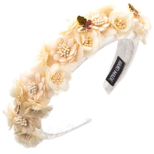 Detailed view of handmade cream tulle flower headband with shimmering butterfly accents