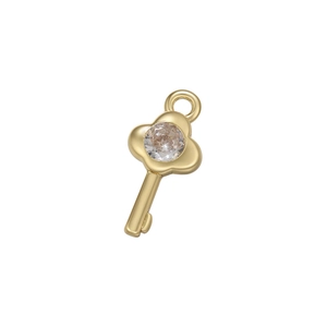 Detail shot of a polished gold key pendant featuring a micro-inset sparkling zircon gem