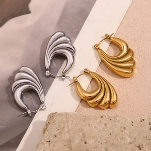 Detailed view of wave textured 18K gold and silver plated C-shape hoop earrings