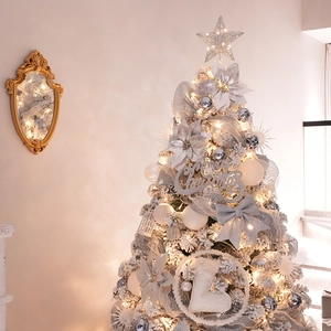Lush artificial Christmas tree with silver ornaments and warm white LED string lights