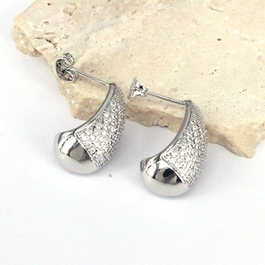 Elegant geometric teardrop stud earrings with pavé zircons on a minimal stone display