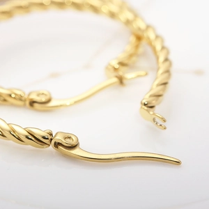 Minimalist twisted rope hoop earrings with 18k gold plating and secure clasp design