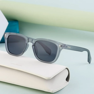 Translucent grey-green square polarized sunglasses with gold arrow studs and white leather case
