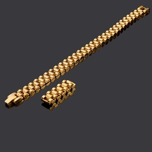 Detail view of golden stainless steel watch band with classic president-style links