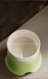 Detail view of 14cm wide ceramic pet bowl with elevated ergonomic green base stand