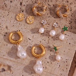 French vintage pearl and gold jewelry collection on natural stone surface set