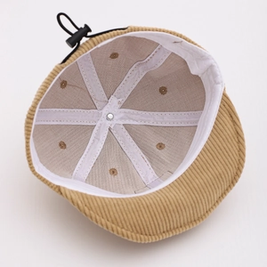 Detailed interior of corduroy baby cap showing white lining and adjustable drawcord
