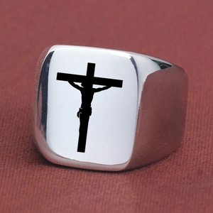 Macro shot of silver stainless steel square ring featuring black engraved crucifix detail