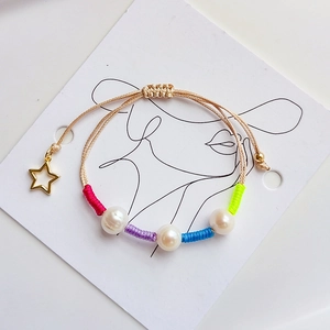 Handmade woven pearl bracelet with gold star pendant and colorful adjustable cord
