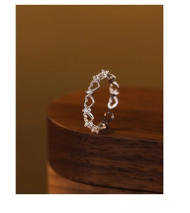 Macro shot of S925 sterling silver hollow heart ring featuring sparkling white zircons