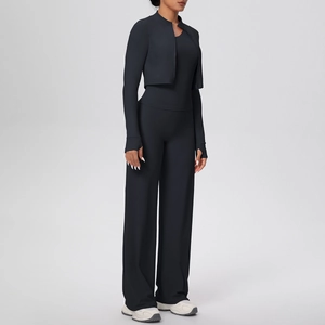 Three-piece yoga set featuring a black zip-up jacket, racerback tank top, and wide-leg pants