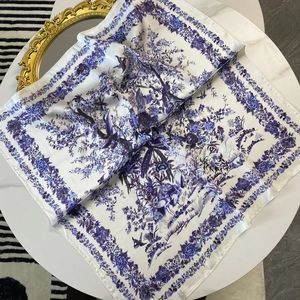 70cm blue and white Toile de Jouy floral silk scarf on a white marble table