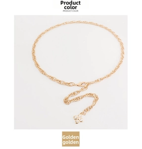 Detail of golden hollow-out chain with rhinestone clover pendant and lobster clasp