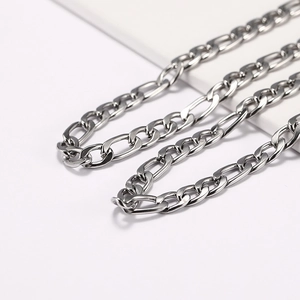 Macro detail of silver stainless steel Figaro chain necklace with a polished metallic finish