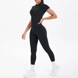 Close-up of black tight-fit yoga jumpsuit with high collar and front zipper detail